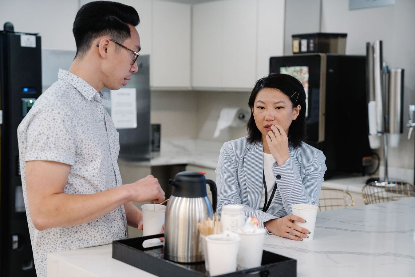 Office workers in a breakroom with a combination vending machine